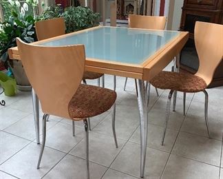 Dania table and 4 chairs set.   Leaf stored underneath can pull out to sit eight   Can be used as a game, dining or kitchen