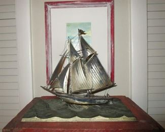 Sterling silver sail boat atop sterling ocean pedestal.