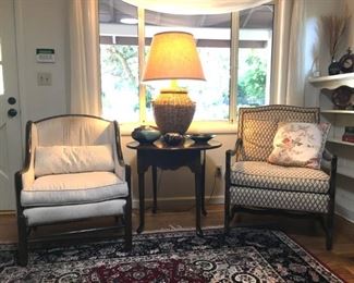 Upholstered side chairs, oak table, wicker lamp, handmade pottery