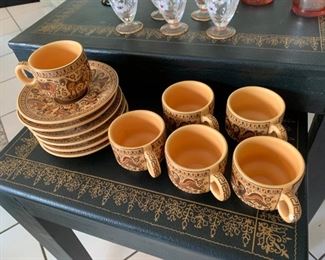 Unique styled tea cups and small plates.