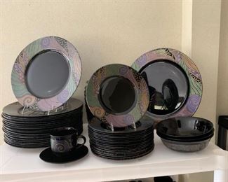 Black plates with colorful design around the edges.