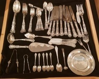 Assorted flatware and individual sterling pieces.