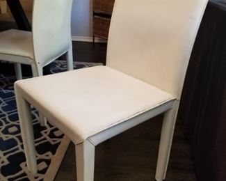 4 white leather chairs
