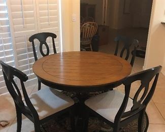 48 inch wide wood table with four quality padded chairs.
