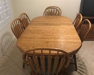 Oak dining table with six oak chairs. Table is 78 1/2 inches long and 41 inches wide.