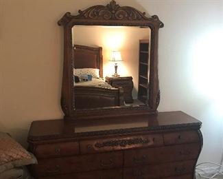 Beautiful carved wood large dresser with granite top. This is a beautiful piece. Matching mirror is 48 inches long by 43 inches high. 