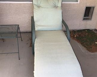 Metal patio chaise with pads.