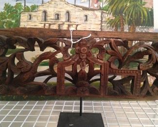 Carved wall hanging; Alamo art in the background