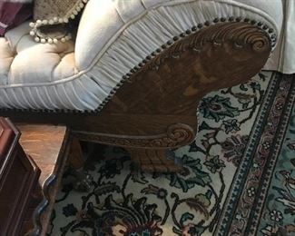 A detail of the oak side rail on the fainting couch