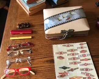 On the desk
Reading glasses cigar rings, an antique photo album, a collection of antique books