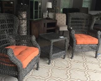 Three pieces of wicker and cushions.