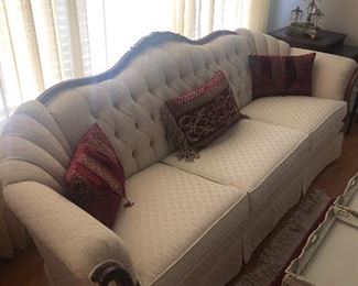 Antique mahogany and cream colored sofa