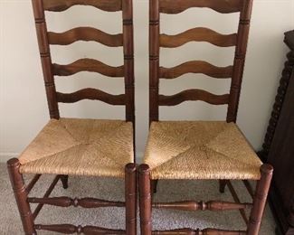 Pair of Davis Cabinet Company walnut ladder back chairs with rush seats
