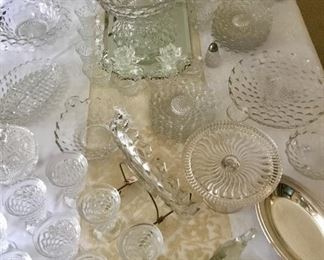 Top view of Large collection of American Fostoria glassware. Punch Bowl, pedestal, relish, tea glasses, juice glasses, console bowls, desert plates, vases, serving bowls etc.