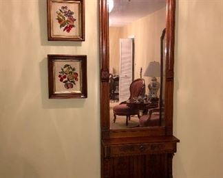 Antique walnut Eastlake pier mirror with antique walnut framed needlepoint fruit pitchers.  