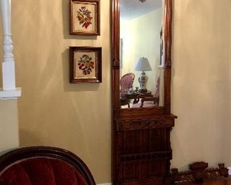 Antique walnut Eastlake pier mirror with the top crown removed.  Shown with antique walnut framed needlepoint fruit pitchers.  