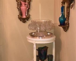 Three shelf painted table with depression area punch bowl and art glass. 