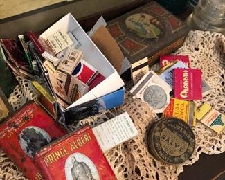 Old tobacco tins alongside vintage cool matchbooks from Mississippi and Las Vegas