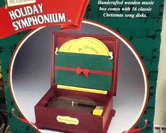 Wooden music box with tin records. This is really a lovely piece and it sounds beautiful. It is new in the box