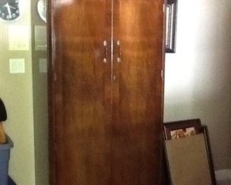 beautiful flame mahogany wardrobe with a carved crest on top