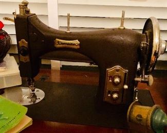 Antique sewing machine with cabinet