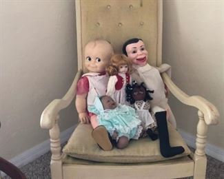 Antique rocker with assorted old dolls