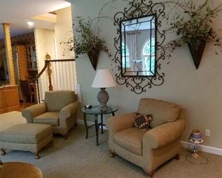 Ornate mirror, floral arrangements, soft easy chairs