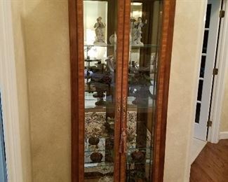 Curio cabinet, full of interesting collectibles.