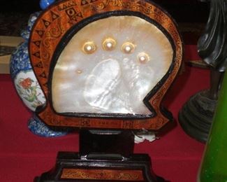 lacquered wood stand with large oyster shell and 4 pearls