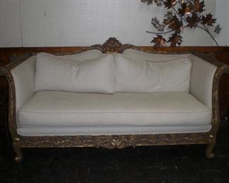 heavily carved and gold leafed box frame sofa with down filled linen upholstery