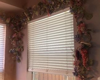 Pretty grapevine wreath window decor. There is actually double the amount you see in this picture.