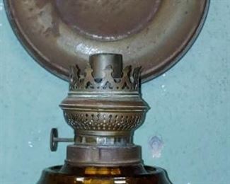 Early amber glass reflector oil lamp