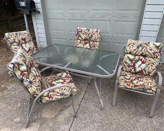 Glass top table and 4 chairs with cushions
3’x5’ Table.