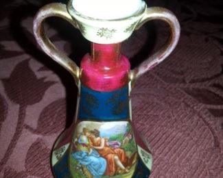 Bud Vase, Signed Austria, gold 64 under blue bee, Two woman embracing being watched by a cupid. Circa 1890-1918