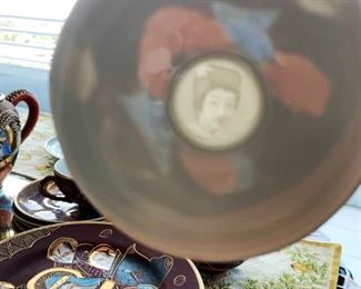 tea cups reveal an image of a geisha girl when held up to the light