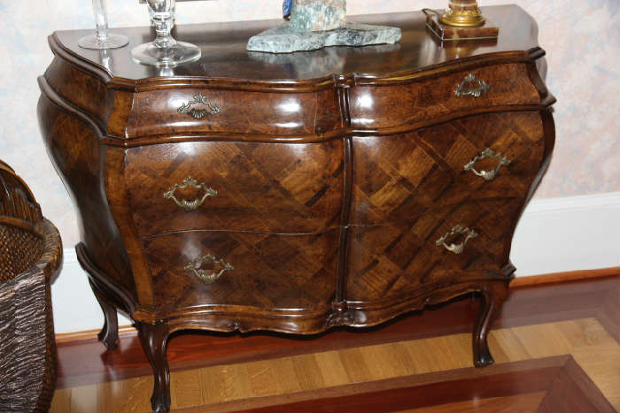Italian-made 3-drawer Bombe chest in foyer with hand inlaid, burled wood geometric parquetry inlay veneers.
