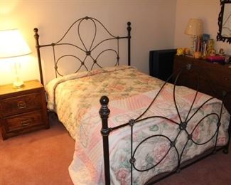 Full size bed shown with chest of drawers and end table.  