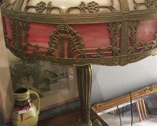 This is the fraternal twin to the other red-toned and caramel Art Nouveau slag glass lamp. Unfortunately, this one has a slight crack in one of the panels. Therefore, this one is $750.