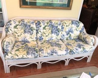 Wicker Sofa with Floral Cushions