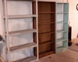 Two wood bookshelves and one plastic garage shelf.