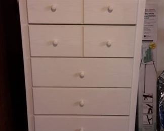 Cute, white particle board 5 drawer dresser. Drawers open very smoothly!
