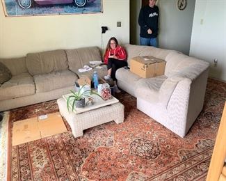 L shape couch and rugs.