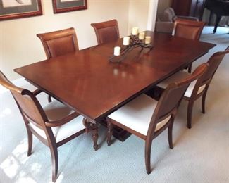 Dining Table and Chairs.  2 Arm Chairs, 4 Side Chairs feature White Cushions and Woven Chair Backs.