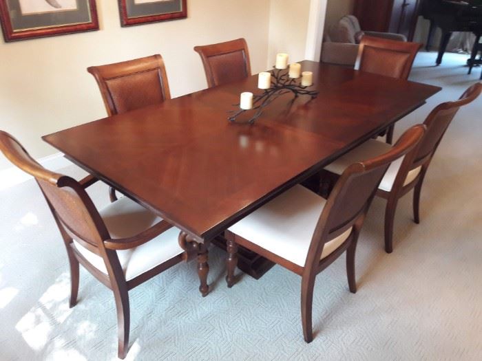 Dining Table and Chairs.  2 Arm Chairs, 4 Side Chairs feature White Cushions and Woven Chair Backs.