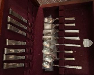 Non tarnishing silver set.  Settings for six.  Includes lines chest.