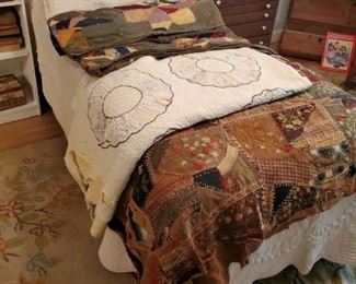 Adjustable electric twin bed and antique quilts