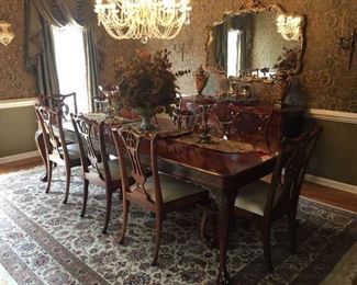 Formal Cherry Dining Room Table that seats 10; the table has 2 captains chairs w/arms (4 of the 10 chairs are coordinating). The table is pictured with 2 leafs and measures 9 Feet (each leaf measures 18"). Price for table and chairs - 2,900.00