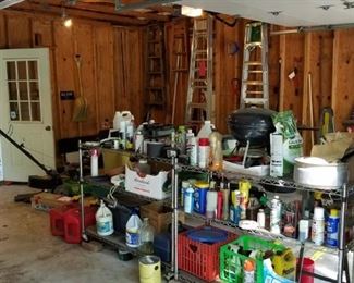 garage full of tools, lawnmowers, John Deere tiller, solvents, hand tools, ladders
