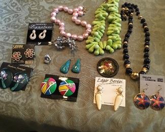 Lots of necklaces, rings, pins, bracelets of all,types and colors