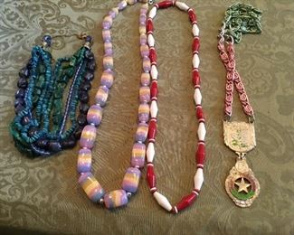 Lots of necklaces, rings, pins, bracelets of all,types and colors